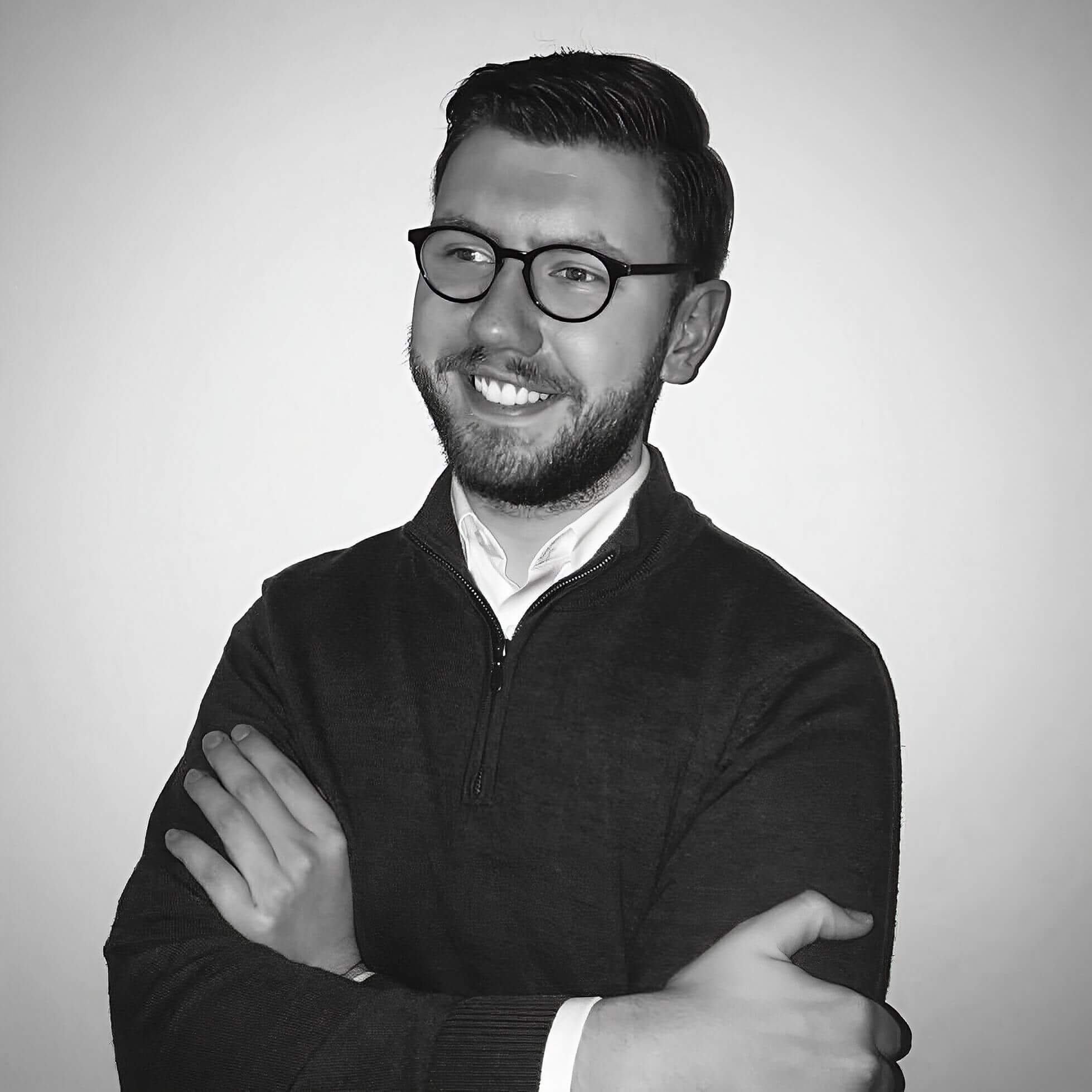 Nathan Wilkins smiling in a black-and-white portrait.